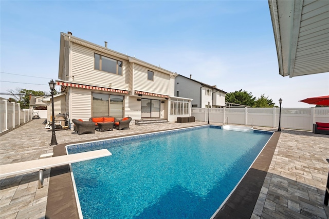3362 Colony Dr, Baldwin Harbor, NY 11510 - view of pool featuring a patio area, an outdoor living space, a diving board, and a fenced backyard