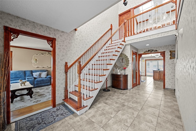 3362 Colony Dr, Baldwin Harbor, NY 11510 - stairway with wallpapered walls, a textured ceiling, and tile patterned floors
