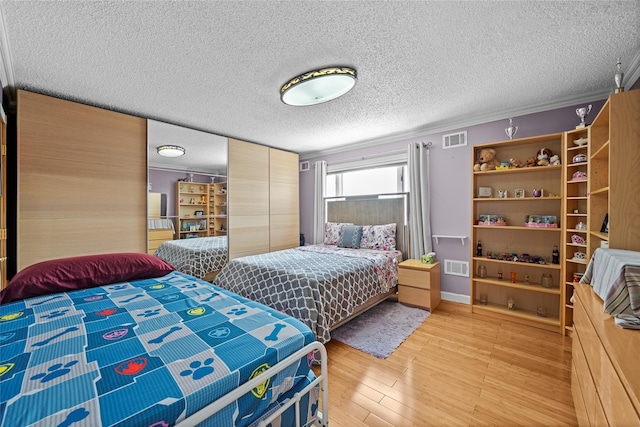 3362 Colony Dr, Baldwin Harbor, NY 11510 - bedroom with light wood-type flooring and a textured ceiling
