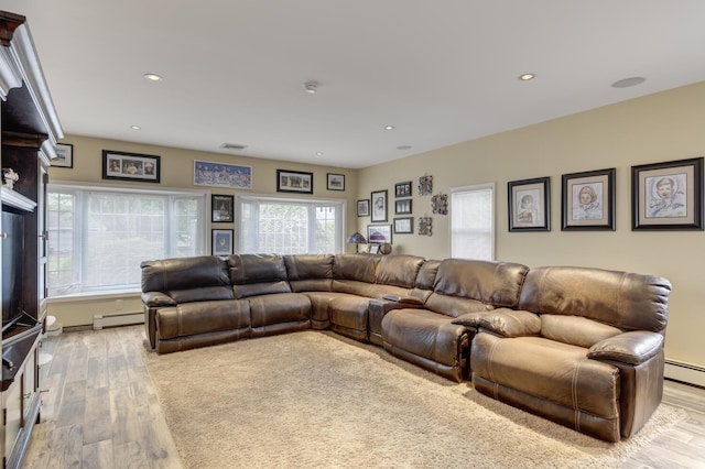18 Loring Rd, Levittown, NY 11756 - living area featuring a baseboard heating unit, light wood finished floors, and recessed lighting