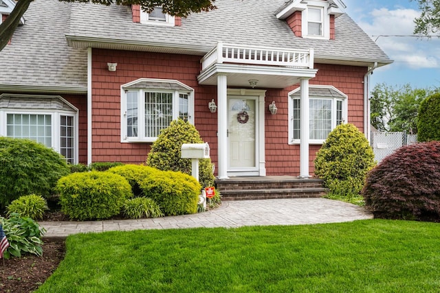 18 Loring Rd, Levittown, NY 11756 - view of front of home with roof with shingles and a front yard