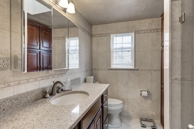 18 Loring Rd, Levittown, NY 11756 - bathroom with tile walls, vanity, and tile patterned flooring