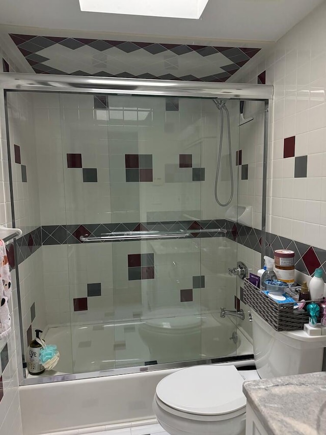 18 Loring Rd, Levittown, NY 11756 - bathroom featuring tile walls, bath / shower combo with glass door, and vanity