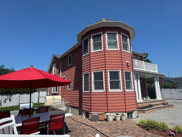 18 Loring Rd, Levittown, NY 11756 - view of side of property featuring a patio, outdoor dining space, and a balcony
