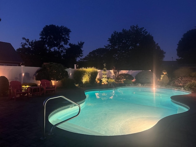 18 Loring Rd, Levittown, NY 11756 - pool at night featuring a fenced backyard