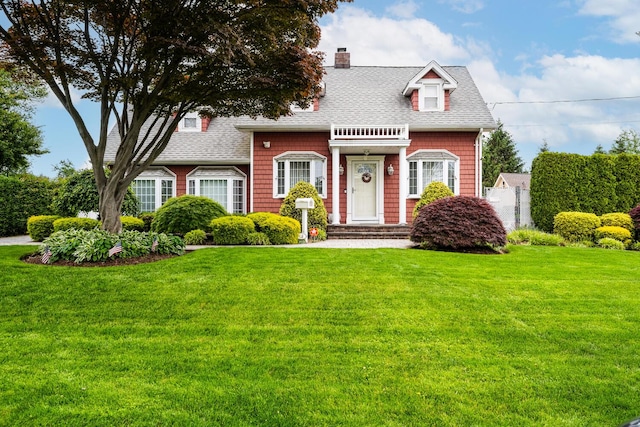 18 Loring Rd, Levittown, NY 11756 - cape cod house with roof with shingles, a front lawn, and a chimney