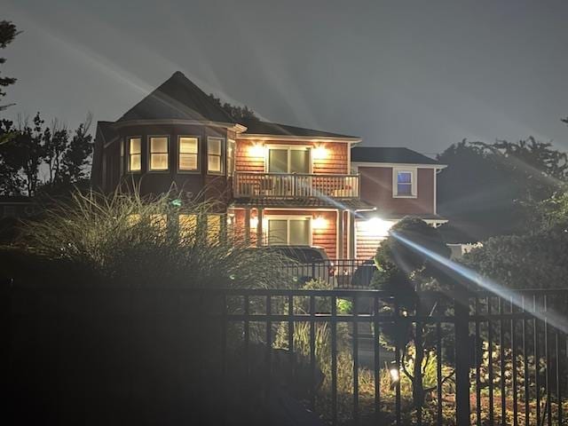18 Loring Rd, Levittown, NY 11756 - back of house at night featuring a balcony