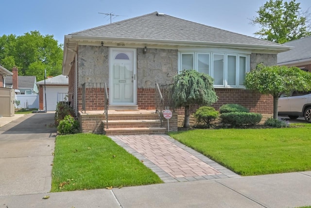 15115 25th Ave, Whitestone, NY 11357 - bungalow-style house with a shingled roof, brick siding, a front lawn, and an outdoor structure