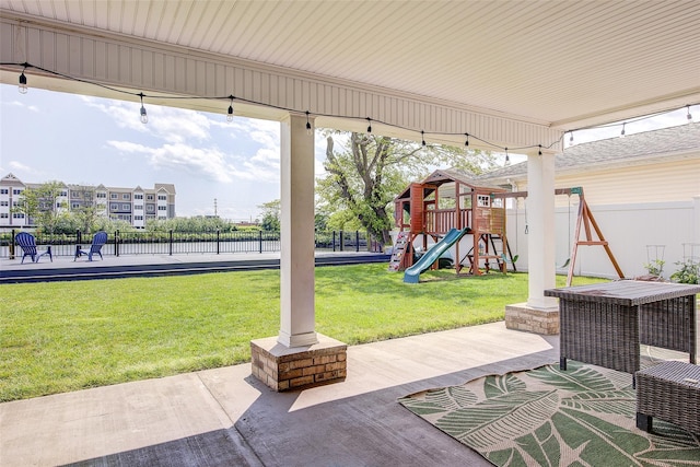 615 Pearl St, Oceanside, NY 11572 - fenced backyard with a playground and a patio area