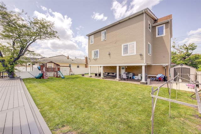 615 Pearl St, Oceanside, NY 11572 - rear view of house featuring a shed, a fenced backyard, a patio area, a playground, and outdoor lounge area