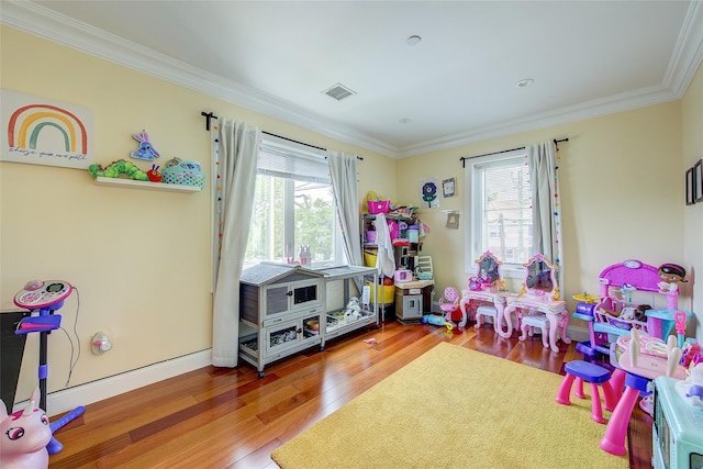 615 Pearl St, Oceanside, NY 11572 - rec room featuring healthy amount of natural light, crown molding, and wood finished floors