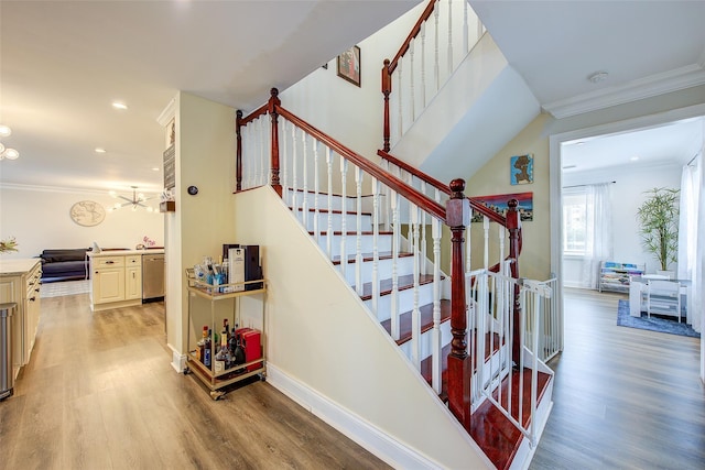 615 Pearl St, Oceanside, NY 11572 - stairway featuring wood finished floors, crown molding, and recessed lighting