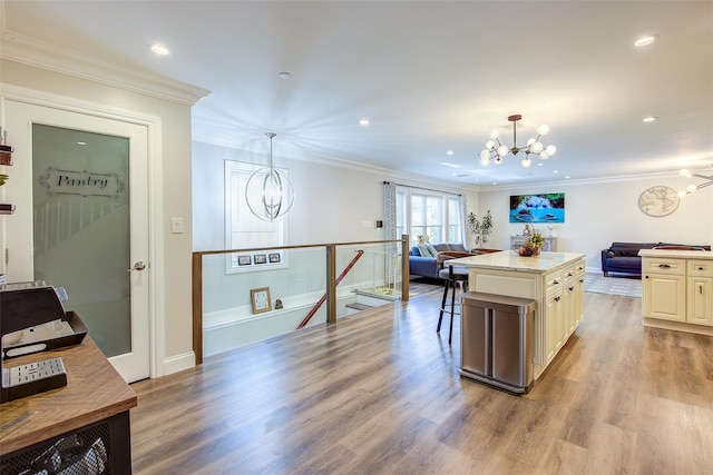 615 Pearl St, Oceanside, NY 11572 - kitchen featuring a chandelier, open floor plan, ornamental molding, wood finished floors, and recessed lighting
