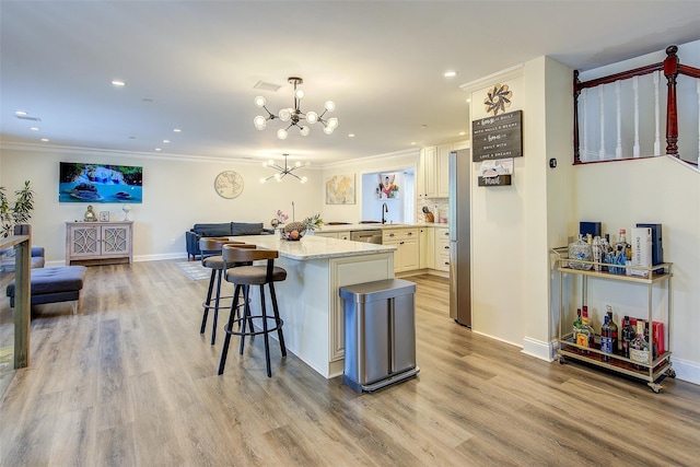 615 Pearl St, Oceanside, NY 11572 - kitchen with open floor plan, a chandelier, ornamental molding, light wood-style floors, and recessed lighting