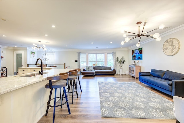 615 Pearl St, Oceanside, NY 11572 - living area featuring a chandelier, crown molding, wood finished floors, and recessed lighting
