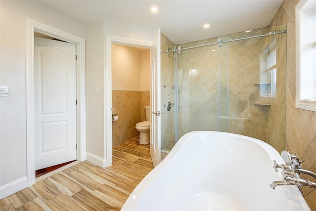 615 Pearl St, Oceanside, NY 11572 - bathroom featuring a soaking tub, tile walls, a stall shower, and wood finished floors