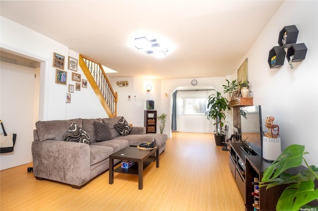 60-09 170th St, Flushing, NY 11365 - living area featuring light wood-style flooring, stairway, and arched walkways