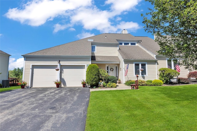 182 Fairway Dr, Carmel, NY 10512 - view of front of property with driveway, an attached garage, a front lawn, a chimney, and a shingled roof