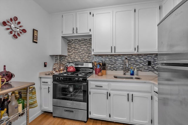 700 Shore Rd Unit 5Ee, Long Beach, NY 11561 - kitchen featuring appliances with stainless steel finishes, decorative backsplash, light countertops, and white cabinets
