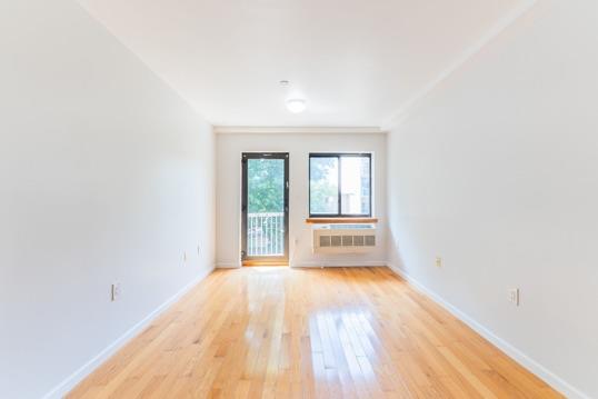 112-26 38th Ave Unit 4A, Corona, NY 11368 - empty room featuring light wood finished floors and baseboards