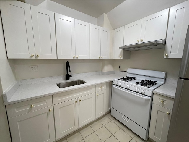 4260 Colden St Unit 4B, Flushing, NY 11355 - kitchen with gas range gas stove, under cabinet range hood, light tile patterned floors, white cabinetry, and light stone countertops