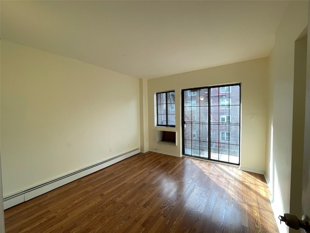 4260 Colden St Unit 4B, Flushing, NY 11355 - unfurnished room featuring baseboard heating and wood finished floors