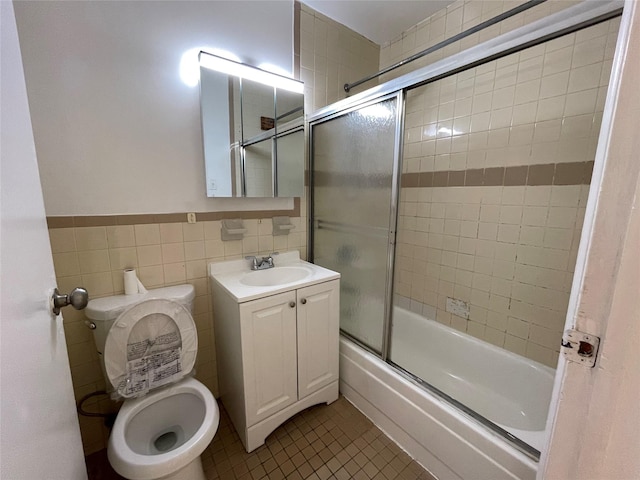 4260 Colden St Unit 4B, Flushing, NY 11355 - bathroom featuring enclosed tub / shower combo, vanity, tile patterned floors, and tile walls