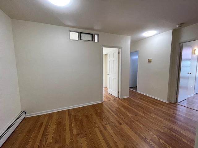 4260 Colden St Unit 4B, Flushing, NY 11355 - unfurnished room featuring baseboard heating, a smoke detector, and wood finished floors