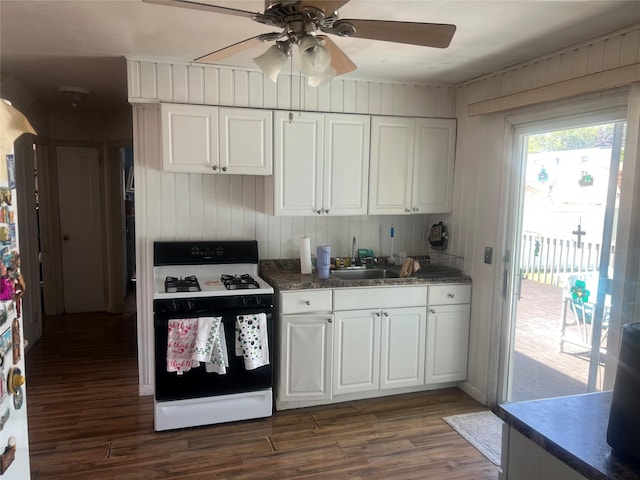159 Van Buren St, West Babylon, NY 11704 - kitchen with gas range oven, dark wood-style flooring, white cabinets, and a ceiling fan