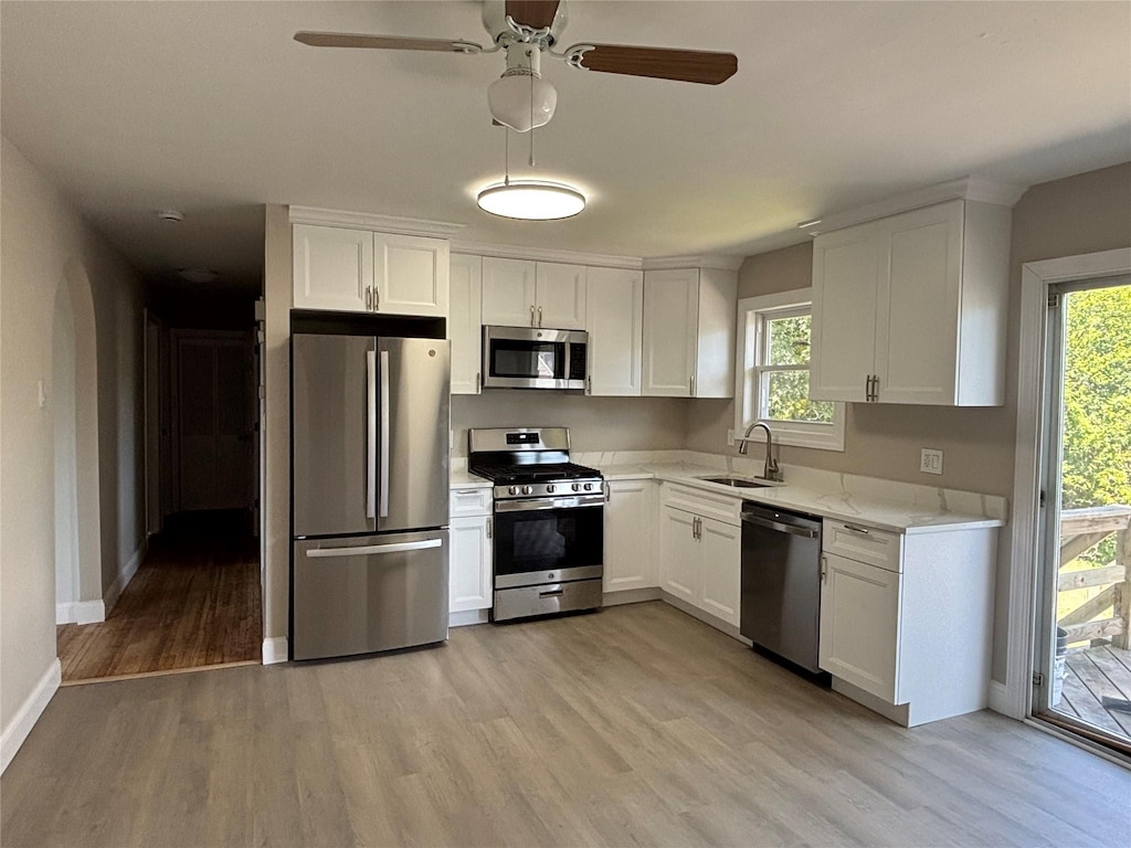 147 Maida Ave, Deer Park, NY 11729 - kitchen with appliances with stainless steel finishes, light wood-type flooring, and white cabinetry