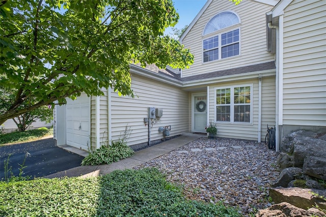 42 Prestwick Ct, Poughkeepsie, NY 12603 - property entrance with asphalt driveway and an attached garage
