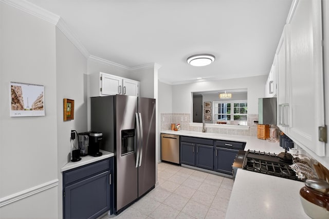 42 Prestwick Ct, Poughkeepsie, NY 12603 - kitchen with stainless steel appliances, light countertops, ornamental molding, white cabinets, and tasteful backsplash