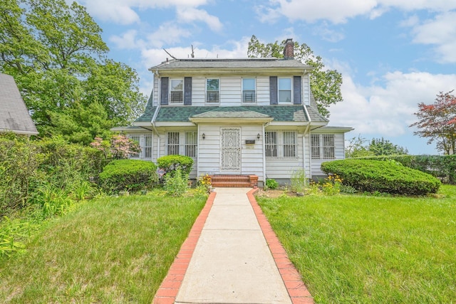 19332 Foothill Ave, Hollis, NY 11423 - view of front of property with a chimney, a shingled roof, and a front yard