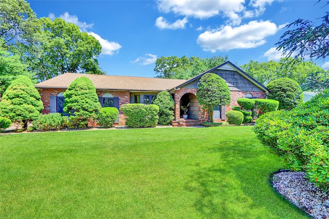 51 Glenridge Ave, Stony Brook, NY 11790 - view of front facade with brick siding, a front lawn, and roof with shingles