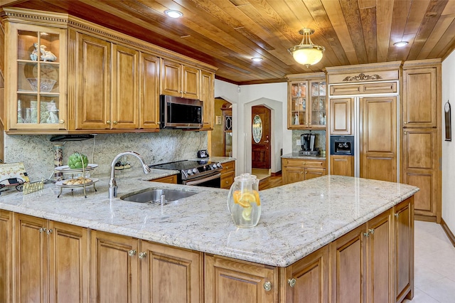 51 Glenridge Ave, Stony Brook, NY 11790 - kitchen with stainless steel appliances, light stone countertops, brown cabinets, backsplash, and recessed lighting