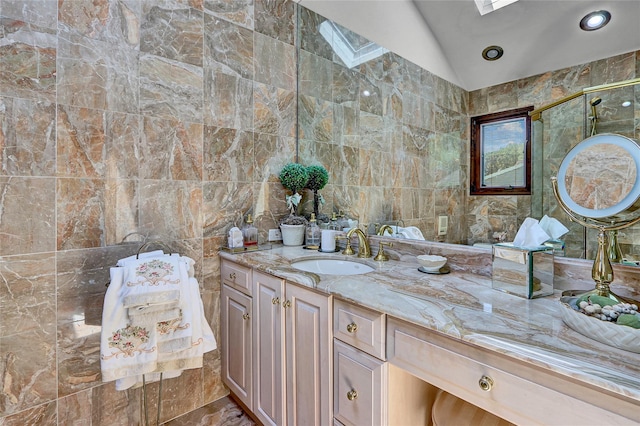 51 Glenridge Ave, Stony Brook, NY 11790 - bathroom featuring vaulted ceiling, vanity, tile walls, and marble finish floors
