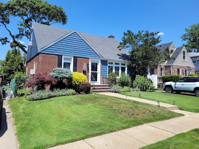 422 Saint Agnes Pl, Franklin Square, NY 11010 - view of front of house with brick siding, a front lawn, a chimney, and a shingled roof