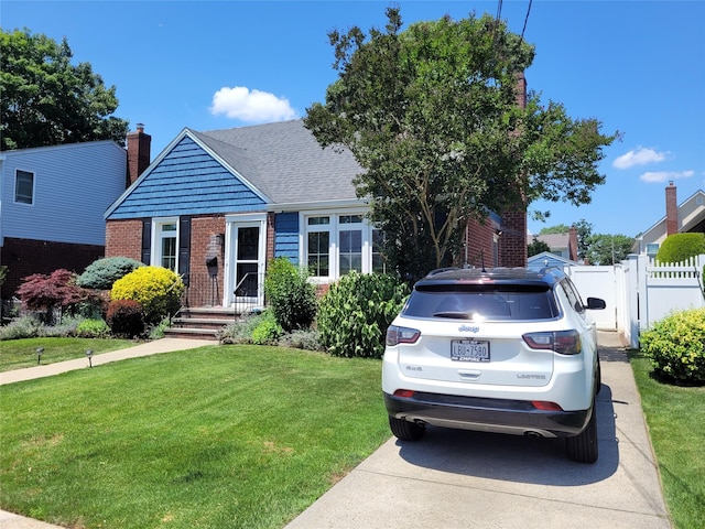 422 Saint Agnes Pl, Franklin Square, NY 11010 - view of front of property with brick siding, a chimney, and a shingled roof