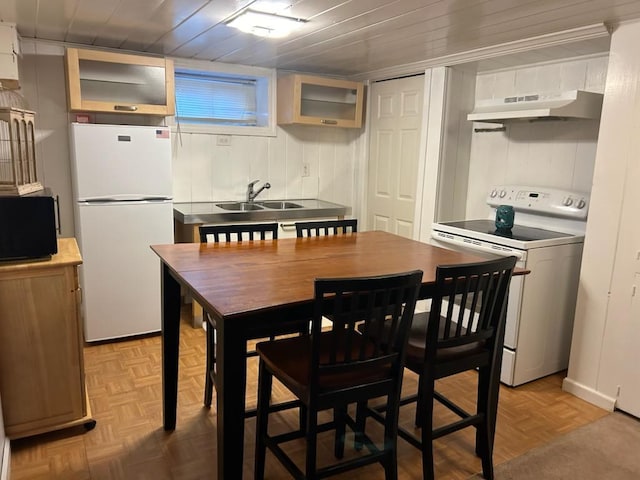 422 Saint Agnes Pl, Franklin Square, NY 11010 - kitchen with white appliances, under cabinet range hood, and glass insert cabinets