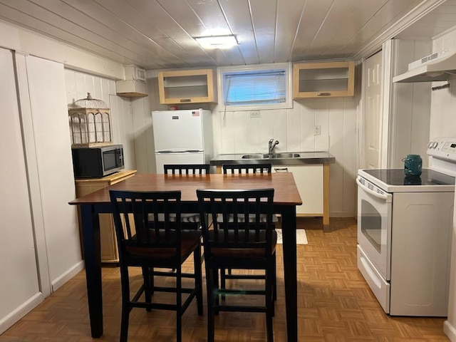 422 Saint Agnes Pl, Franklin Square, NY 11010 - kitchen featuring white appliances, under cabinet range hood, glass insert cabinets, and wooden ceiling