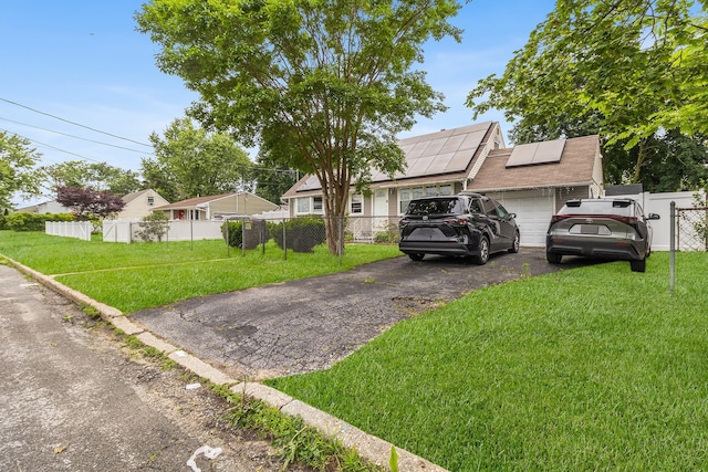 15 E Walnut St, Central Islip, NY 11722 - view of front of house featuring solar panels, asphalt driveway, a garage, and a gate