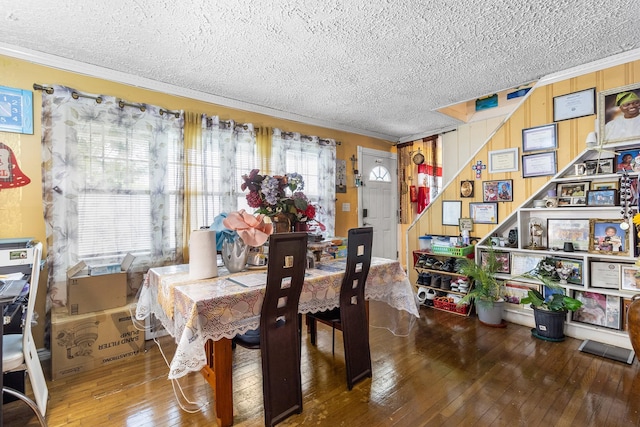 15 E Walnut St, Central Islip, NY 11722 - dining area with crown molding, a textured ceiling, and wood-type flooring
