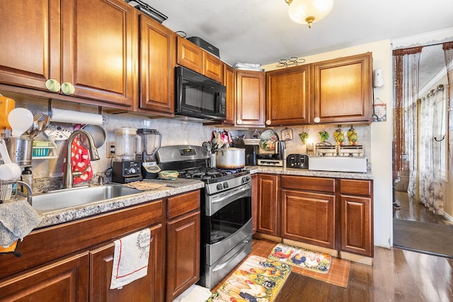15 E Walnut St, Central Islip, NY 11722 - kitchen with black microwave, stainless steel range with gas stovetop, light countertops, and brown cabinetry