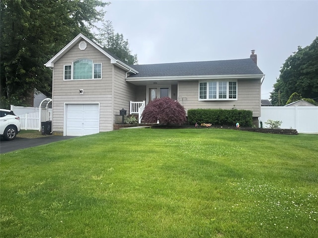 8 Primrose Ln, Kings Park, NY 11754 - split level home with a chimney, an attached garage, and asphalt driveway