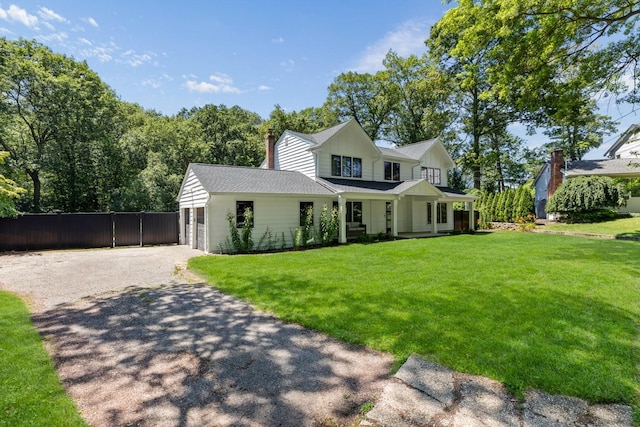 9 Guthrie Ct, East Northport, NY 11731 - view of front of home featuring asphalt driveway, covered porch, a chimney, an attached garage, and board and batten siding