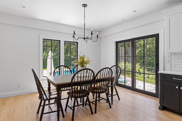 9 Guthrie Ct, East Northport, NY 11731 - dining area with a chandelier, plenty of natural light, and light wood-style floors