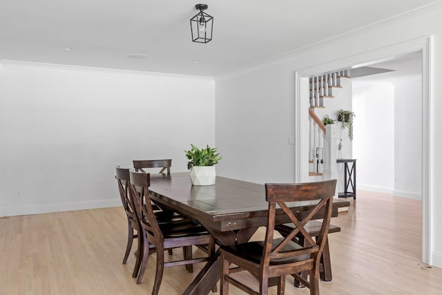 9 Guthrie Ct, East Northport, NY 11731 - dining space featuring light wood-style flooring, stairs, and crown molding
