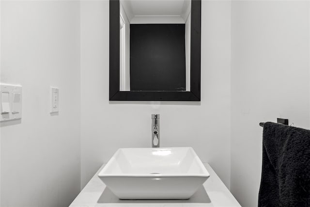9 Guthrie Ct, East Northport, NY 11731 - bathroom featuring a sink and crown molding