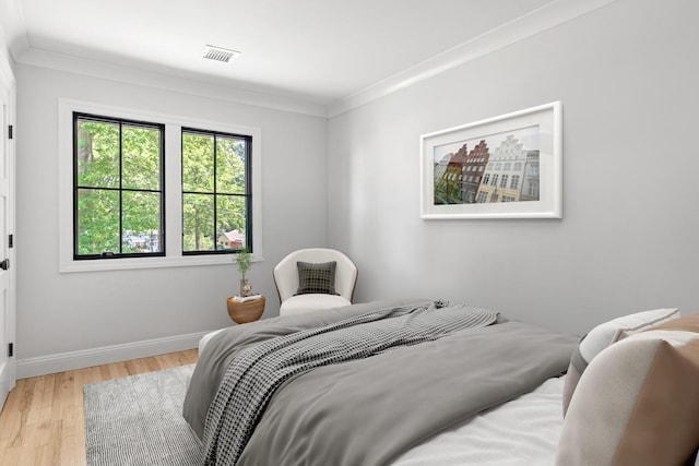 9 Guthrie Ct, East Northport, NY 11731 - bedroom with light wood-type flooring and crown molding