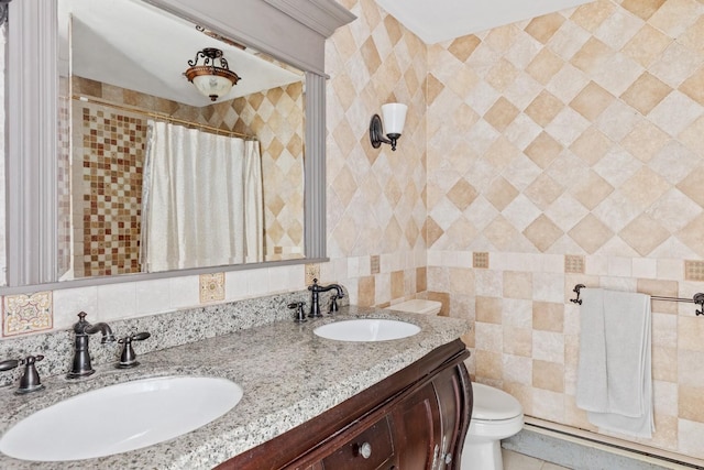 9 Guthrie Ct, East Northport, NY 11731 - bathroom featuring double vanity, curtained shower, baseboard heating, tile walls, and tile patterned floors